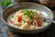 Saltfish em molho de leite de coco, servido com coentros frescos